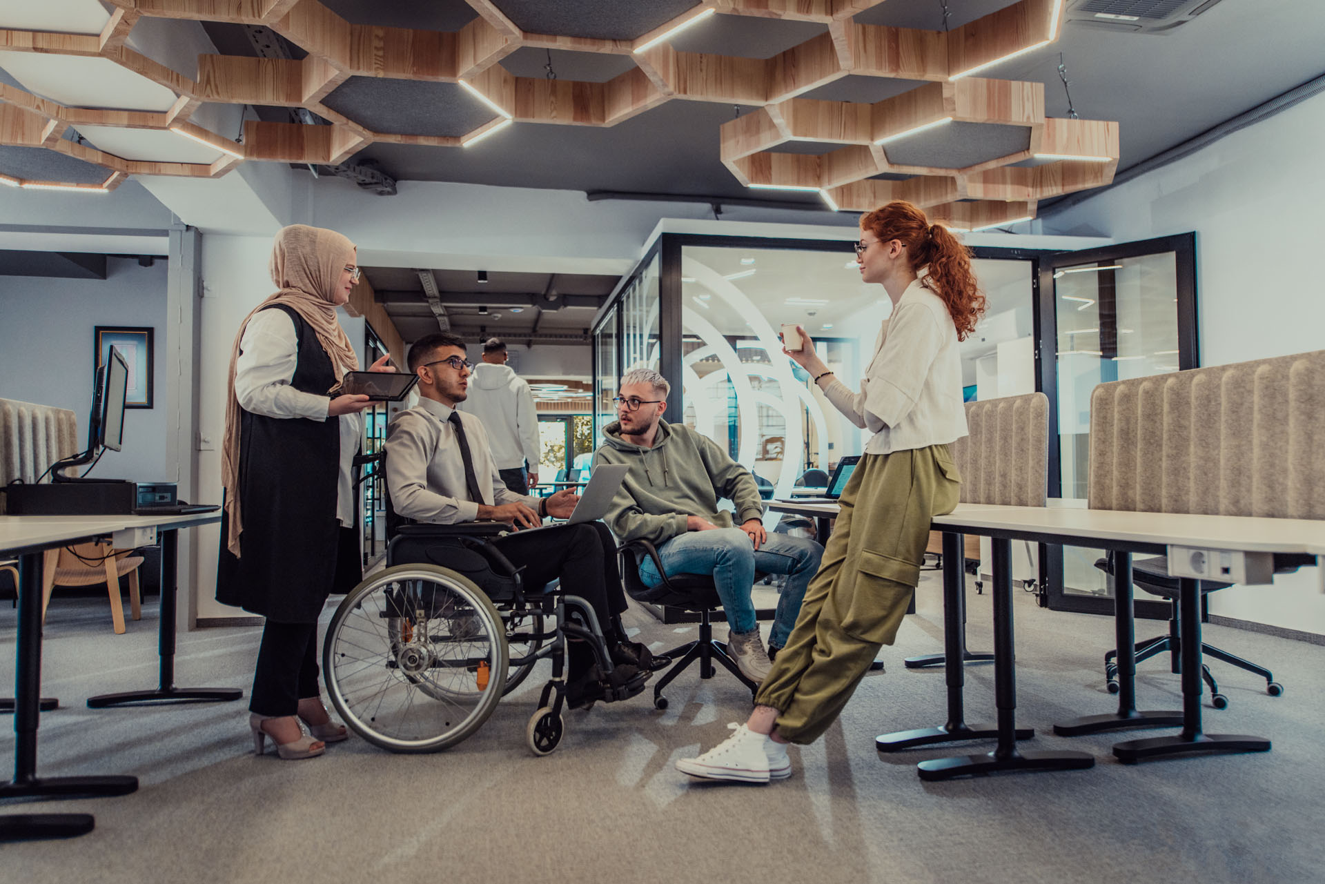 A diverse young group of business people brainstorming together in a startup space, discussing business projects, and solving challenges.